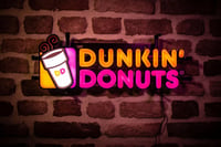 Dunkin Donuts LED neon sign on a brick wall